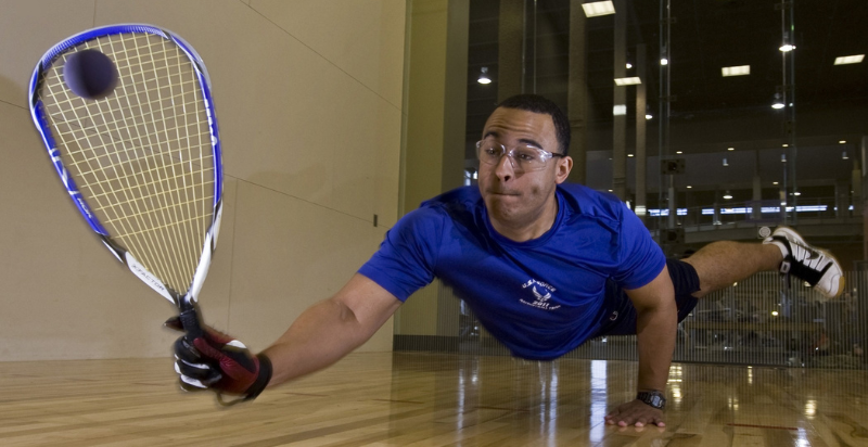 a flying Racquetball player hitting Racquetball
