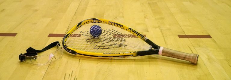 a racquetball racquet with ball and vibration dampener